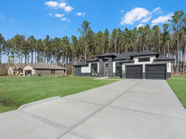 view of front of house with a garage and a front lawn