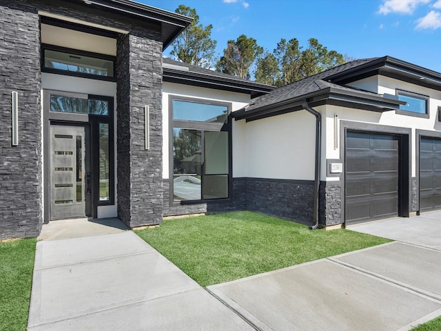 property entrance with a lawn