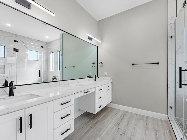 bathroom with vanity, wood-type flooring, and an enclosed shower