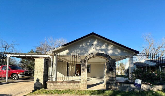 bungalow-style home featuring a porch and a carport