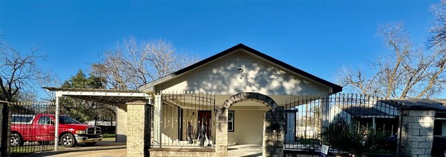 view of front of property featuring a carport