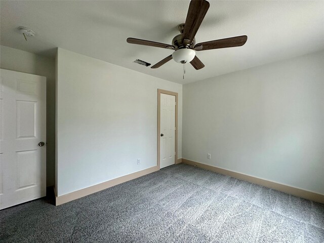 carpeted empty room featuring ceiling fan