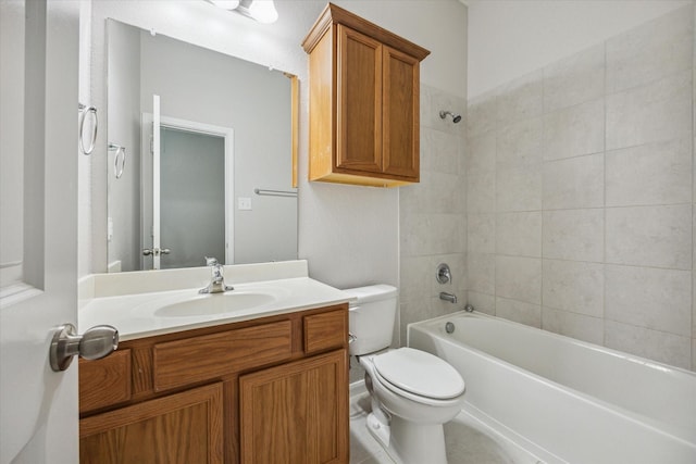 full bathroom featuring tiled shower / bath combo, toilet, and vanity