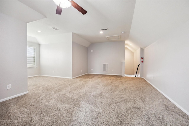 interior space with carpet, ceiling fan, and vaulted ceiling