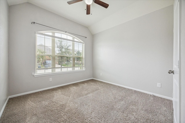 carpeted empty room featuring ceiling fan and vaulted ceiling