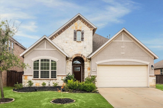 view of front of home featuring a front lawn and a garage