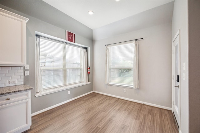 unfurnished dining area with light hardwood / wood-style floors