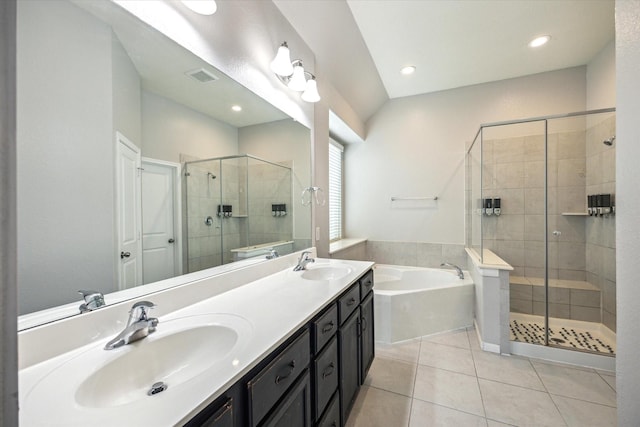 bathroom featuring tile patterned flooring, vanity, and separate shower and tub