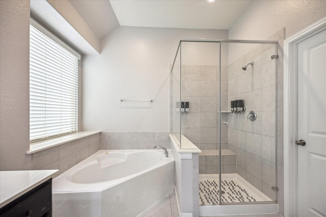 bathroom featuring vanity, vaulted ceiling, and separate shower and tub