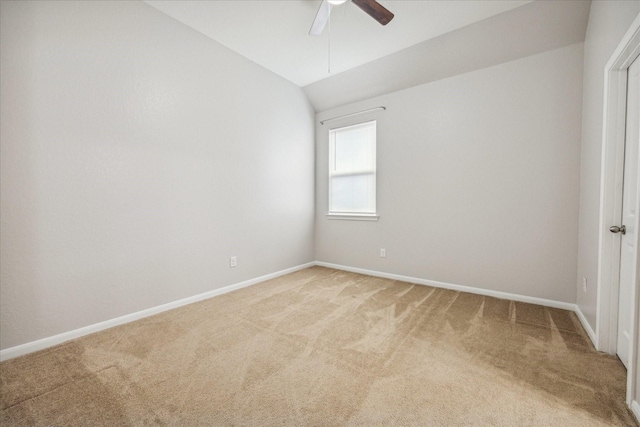 spare room with carpet, ceiling fan, and lofted ceiling