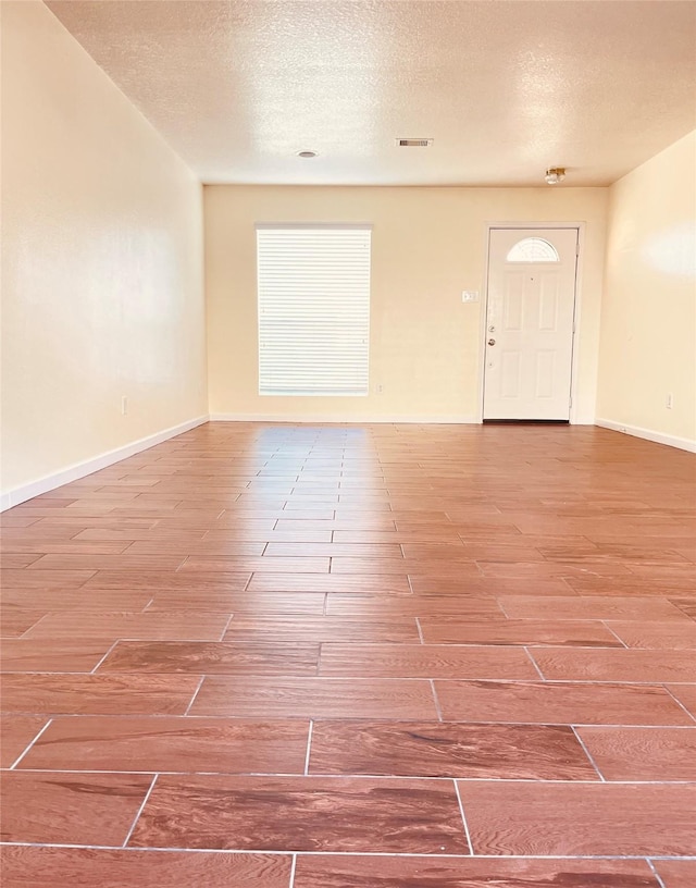 empty room featuring a textured ceiling