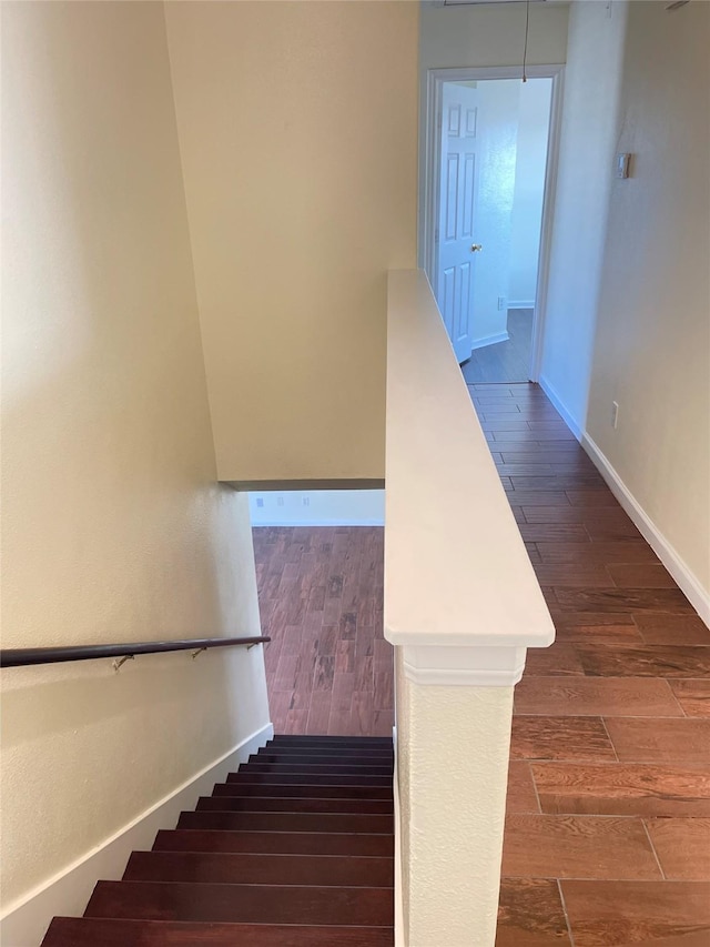 staircase with wood-type flooring