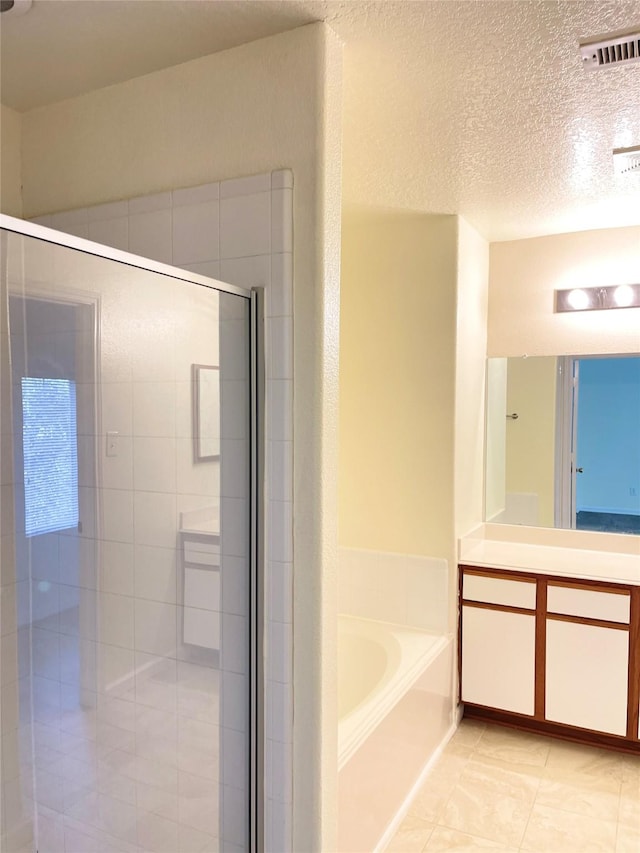 bathroom featuring tile patterned flooring, vanity, independent shower and bath, and a textured ceiling