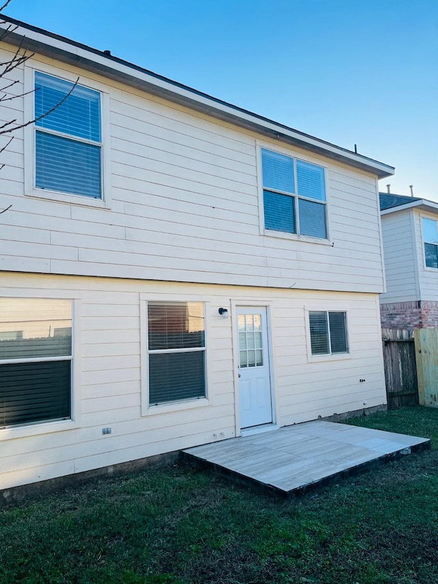 back of house featuring a lawn and a patio area