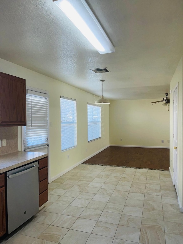 kitchen with ceiling fan, dishwasher, hanging light fixtures, a textured ceiling, and decorative backsplash