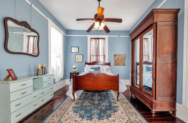 bedroom featuring ceiling fan and dark wood-type flooring