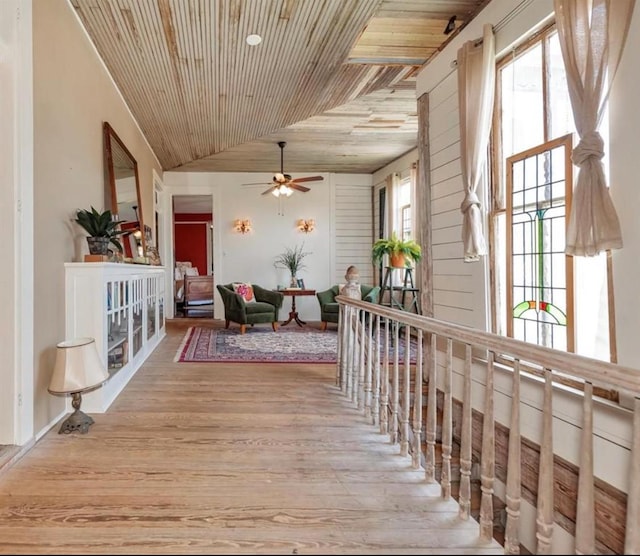 interior space with ceiling fan, wooden ceiling, and vaulted ceiling