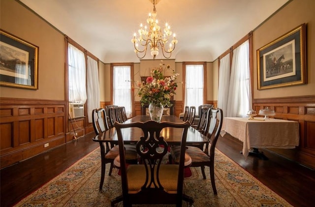 dining space with a chandelier, dark hardwood / wood-style flooring, and cooling unit