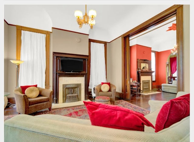 living room with dark wood-type flooring and a chandelier