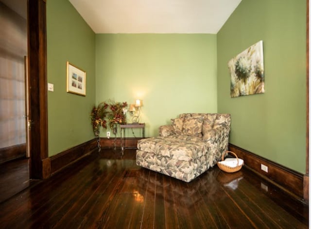 sitting room featuring hardwood / wood-style floors and vaulted ceiling