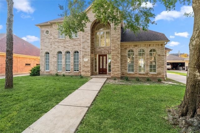 view of front facade with french doors and a front lawn