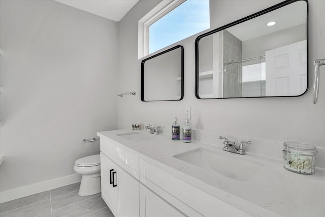 bathroom featuring tile patterned floors, vanity, toilet, and a shower