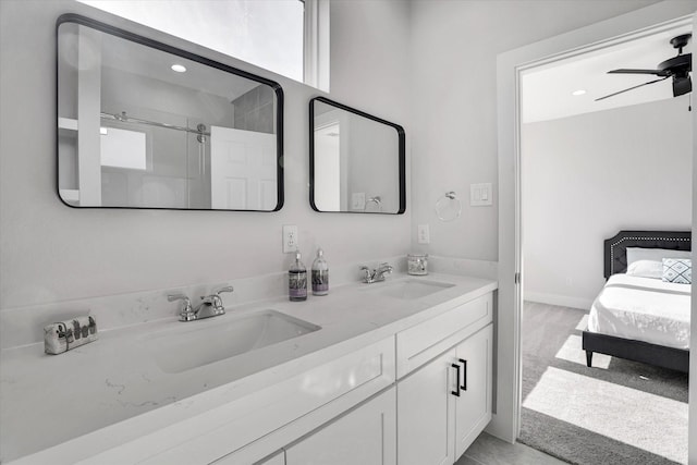 bathroom featuring walk in shower, vanity, and ceiling fan