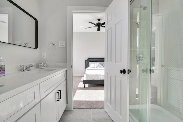 bathroom with ceiling fan, tile patterned flooring, vanity, and walk in shower