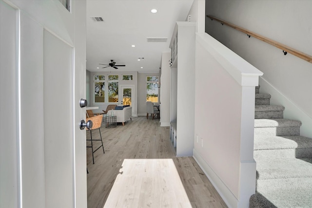 hallway featuring french doors and light hardwood / wood-style floors