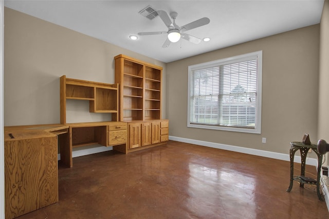 unfurnished office with ceiling fan and built in desk