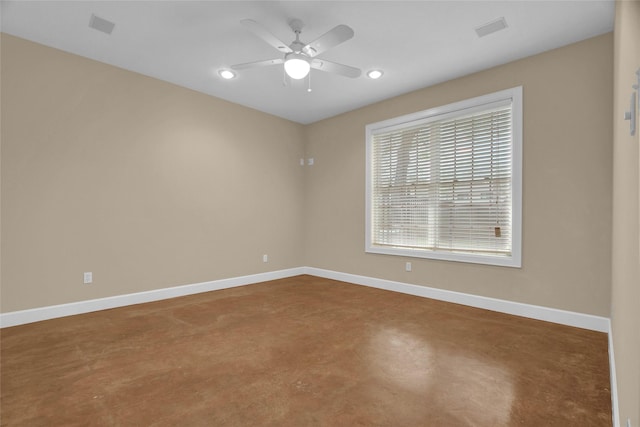 unfurnished room featuring ceiling fan and concrete floors