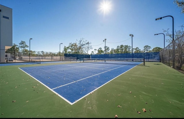 view of tennis court with fence