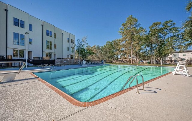 view of swimming pool featuring a patio area