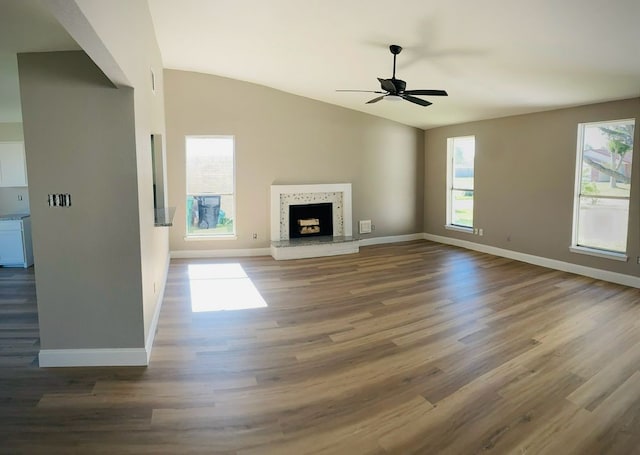 unfurnished living room with hardwood / wood-style floors, ceiling fan, and lofted ceiling