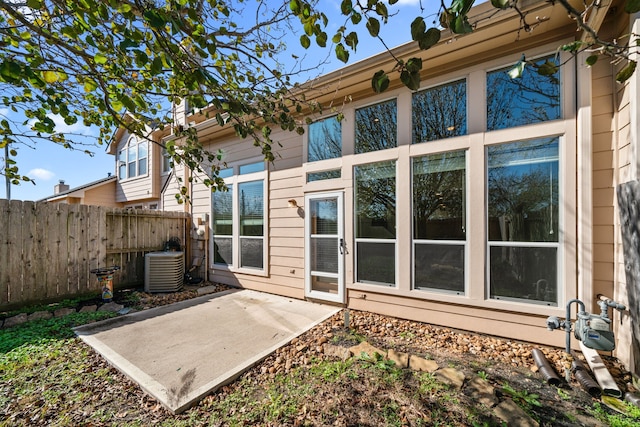 rear view of house with a patio and central AC unit