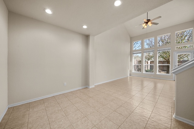 tiled spare room with ceiling fan and lofted ceiling