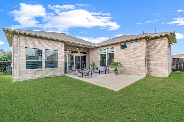 back of house featuring a lawn, ceiling fan, a patio area, and an outdoor living space