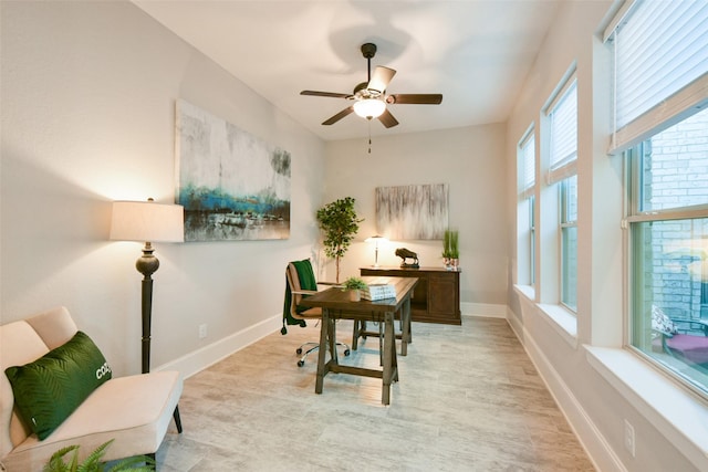 office area with ceiling fan, light hardwood / wood-style floors, and a wealth of natural light