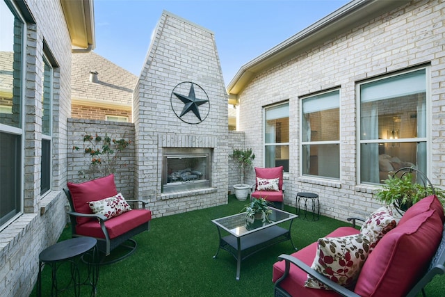 view of patio featuring an outdoor living space with a fireplace