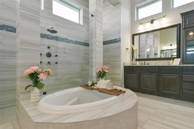 bathroom with tile patterned flooring, vanity, and independent shower and bath