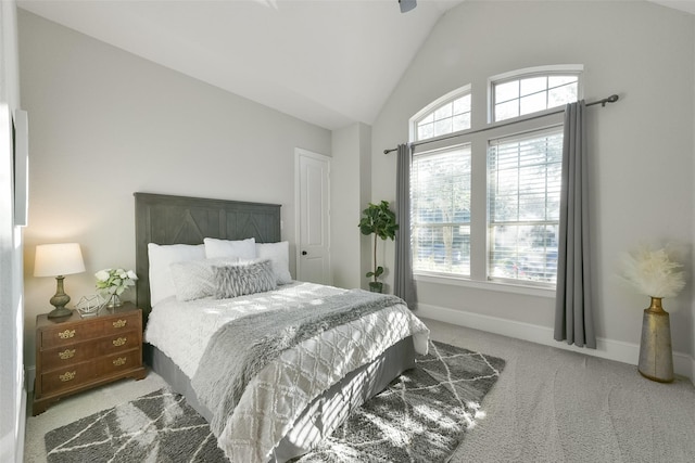 carpeted bedroom featuring lofted ceiling