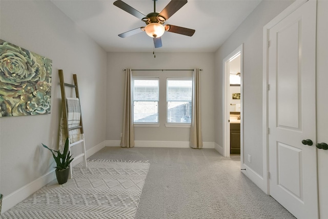 doorway to outside with light colored carpet and ceiling fan