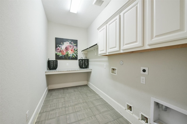 clothes washing area with hookup for a gas dryer, cabinets, washer hookup, and hookup for an electric dryer