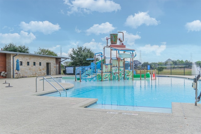 view of swimming pool featuring a playground and a water slide