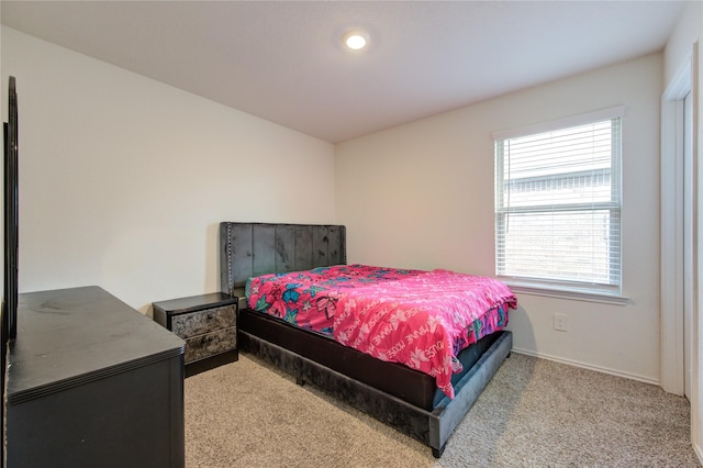 bedroom featuring light colored carpet