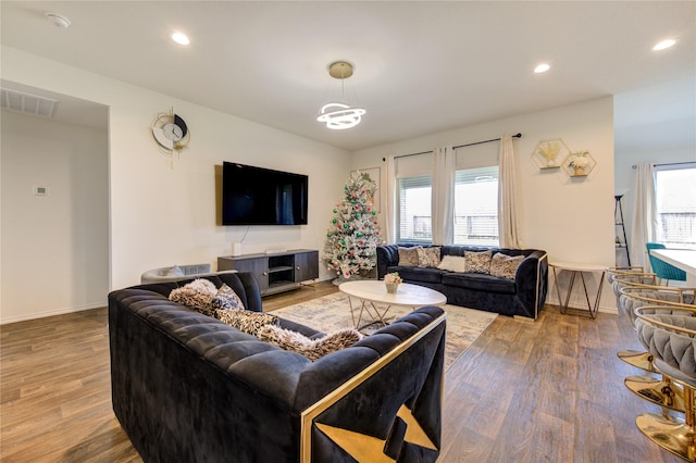 living room featuring hardwood / wood-style flooring and a notable chandelier