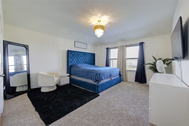 carpeted bedroom with a notable chandelier