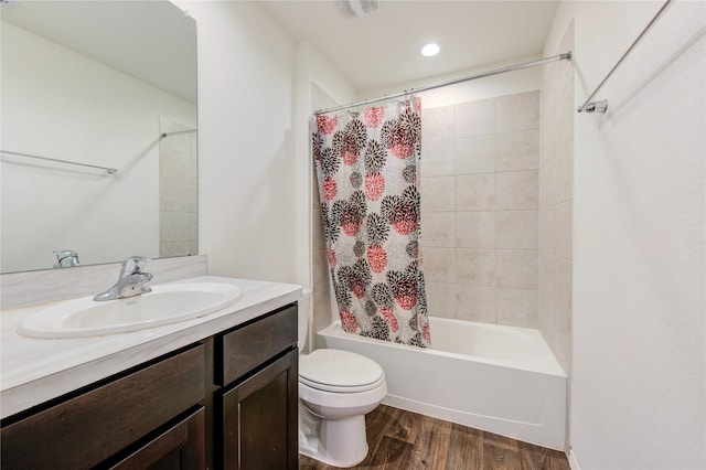 full bathroom featuring shower / bath combo with shower curtain, vanity, wood-type flooring, and toilet