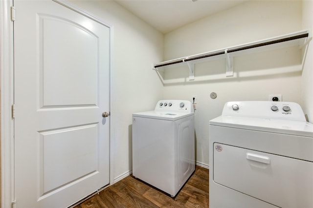 clothes washing area featuring washer and dryer and dark wood-type flooring