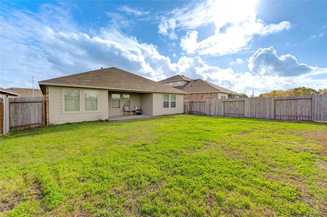 back of house with a lawn